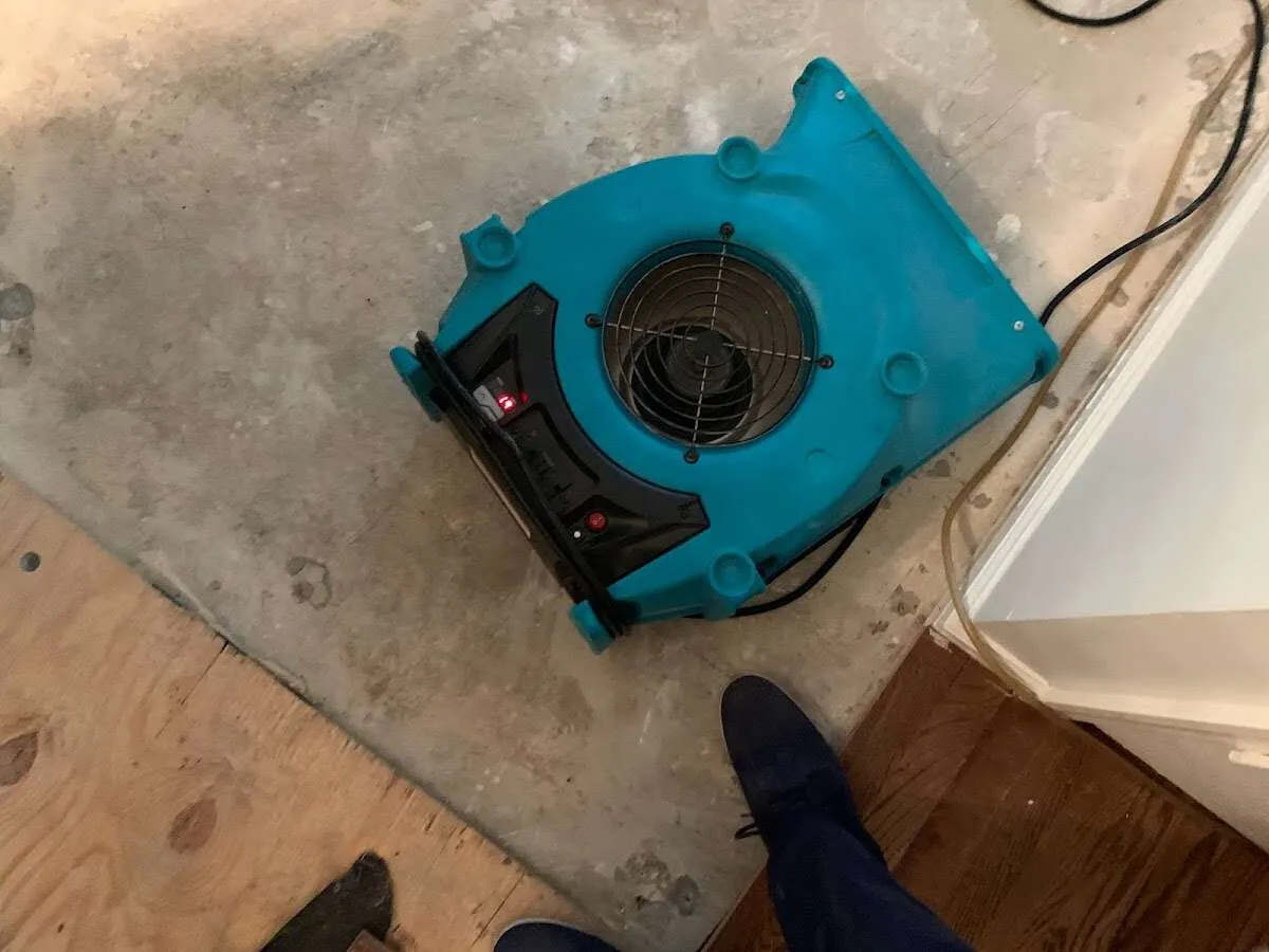 Air mover drying subfloor during Leak Detection & Repair in Kimberly